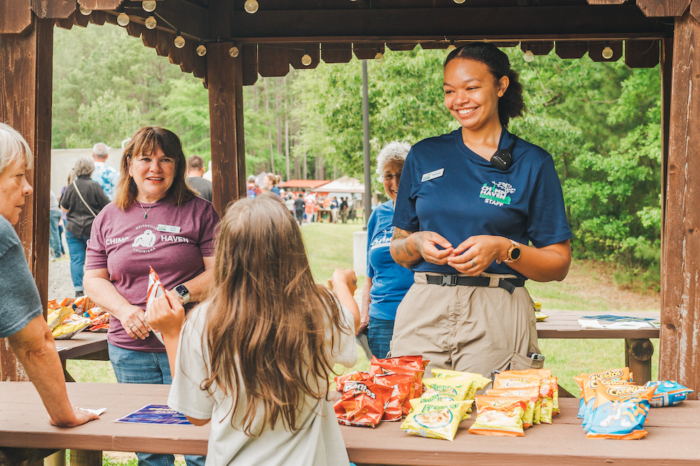 staff feeding guests